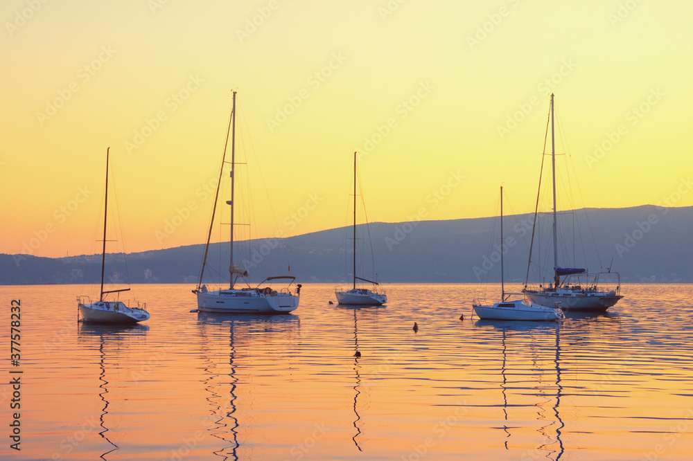 Autumn sunset with sailboats on water. Kotor Bay, Tivat, Montenegro