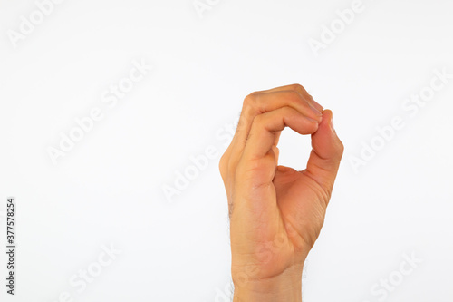 close up of a man's hand communicating with sign language, letters of the alphabet, on a white background