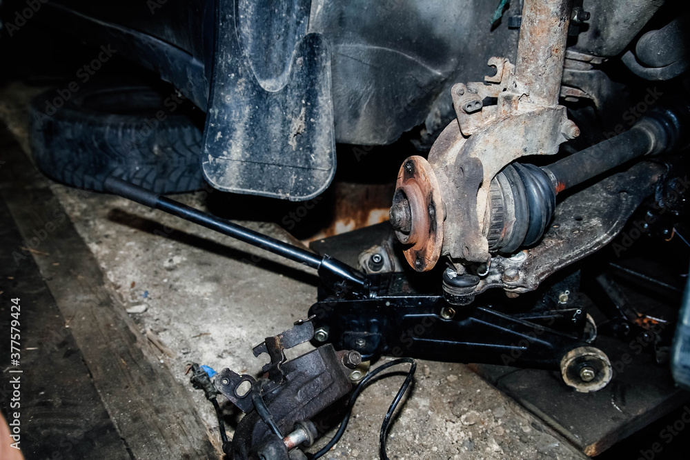 mechanic removes the car wheel hub.