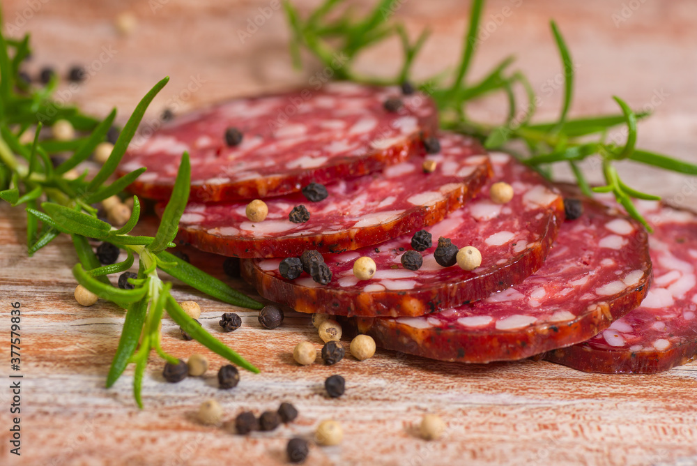 salami slices with pepper and rosemary salami slices with pepper and rosemary