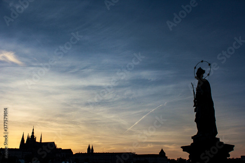 Silhouette of Prague city with colorful sky and sculptures