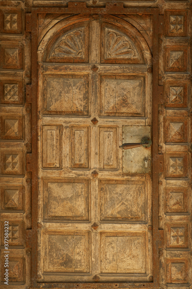 Ancient closed wooden door with handle 