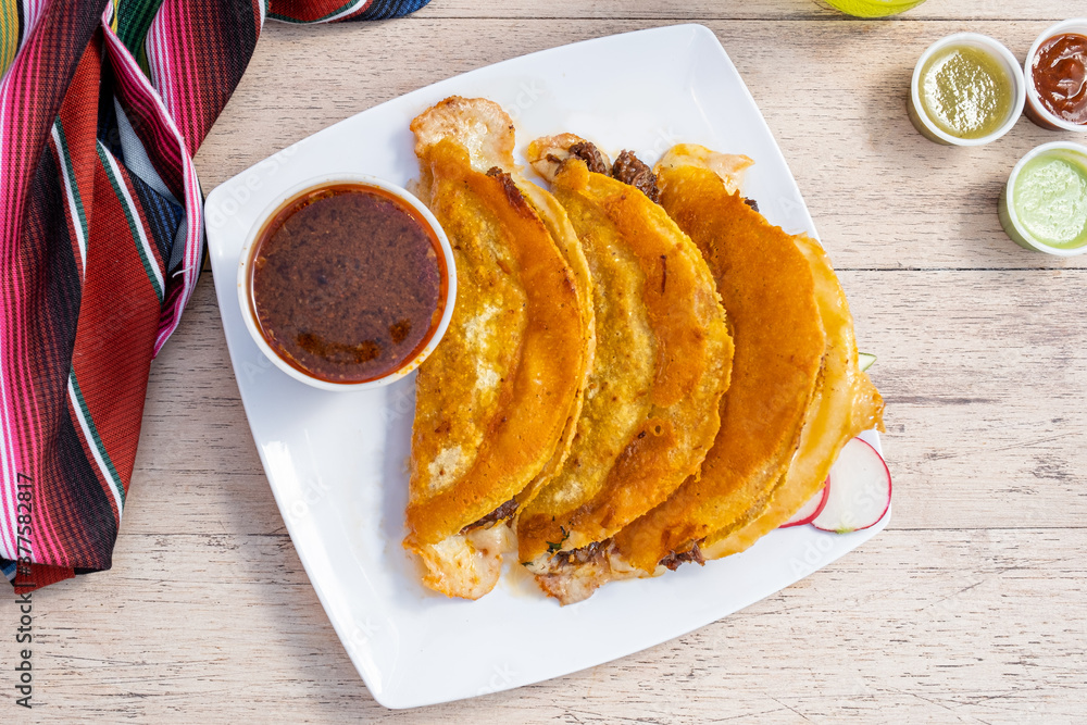 Authentic birria tacos for dipping. Mexican street food made with corn