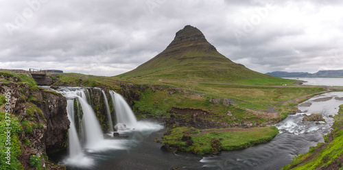 panoramic view of a mountain in the distance and two waterfall in the foreground