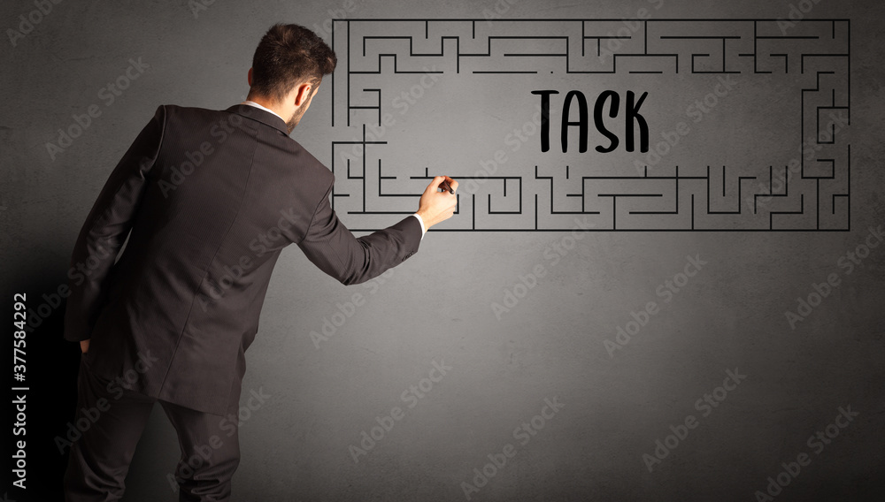 businessman drawing maze with TASK inscription, business education concept