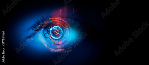 Close-up biometric scan of a female eye. The concept of modern virtual reality. Neon light, cyber background.