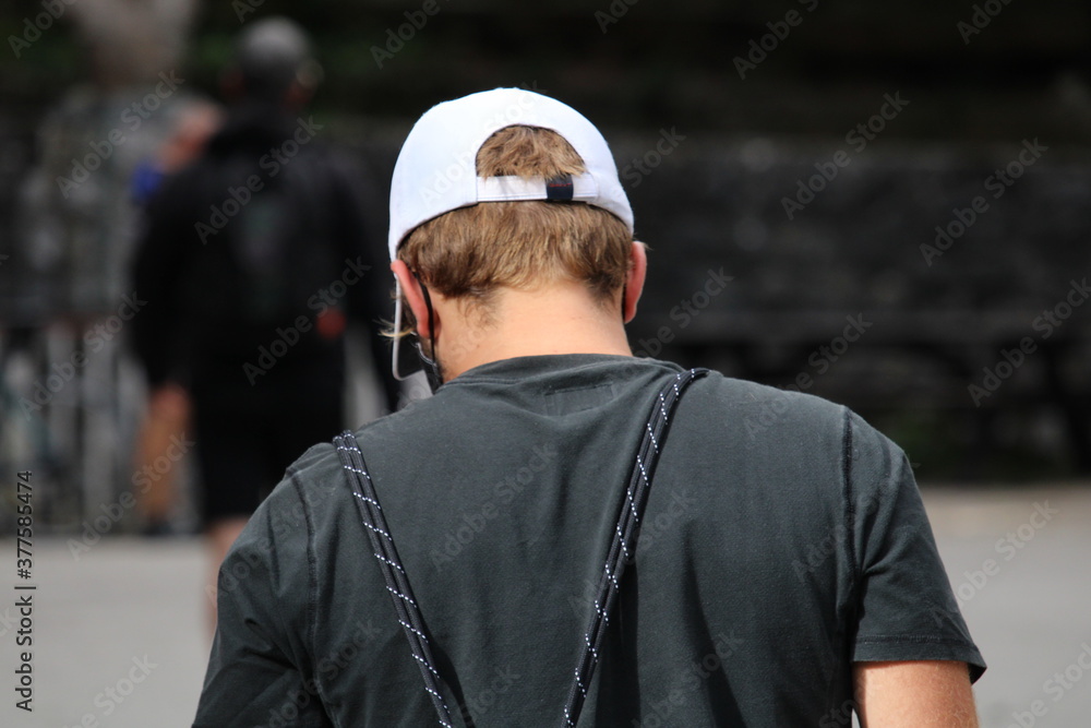 Young boy from behind looking at the horizon
