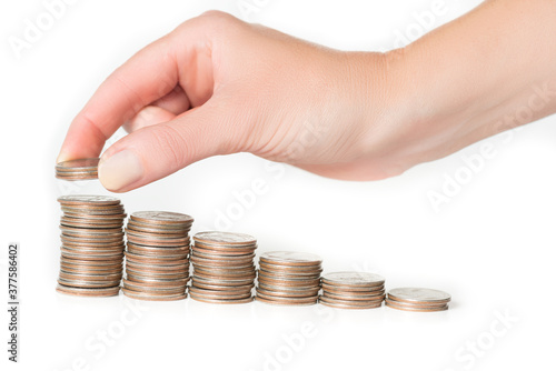 Woman hand stacking US quarters into increasing columns 