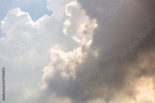 Looking up to moody clouds, weather is changing visibly in the sky and rain is on the way. sunlight is creeping through. Textured graphic design resource