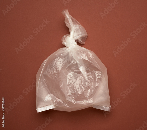 blank transparent plastic bag on brown background