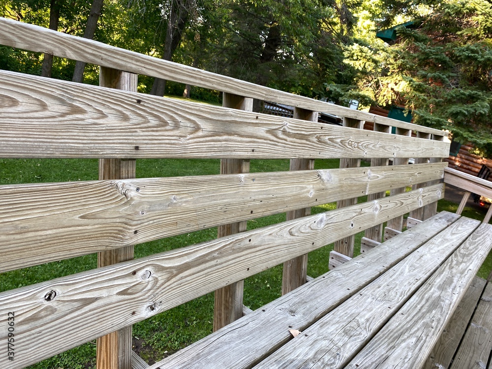 wooden bench outside in the summer time wooden bench outside in the summer time