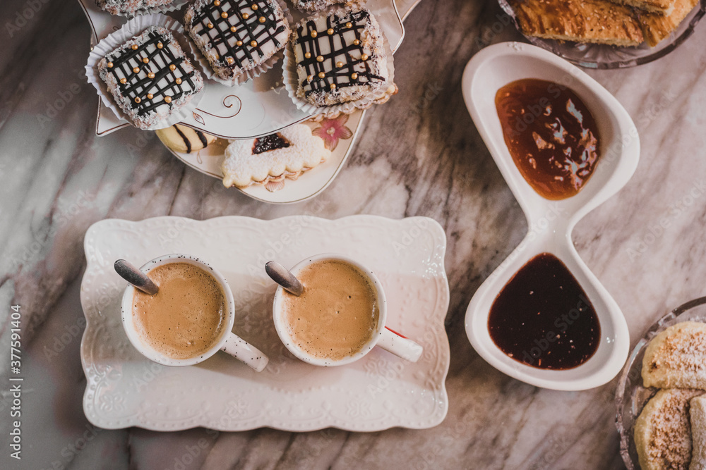 Cup of cappuccino coffee sweetening and white homemade candies on wooden table . cappuccino or espresso coffee with milk put on a wood table Cup of cappuccino coffee sweetening and white homemade candies on wooden table . cappuccino or espresso coffee with milk put on a wood table