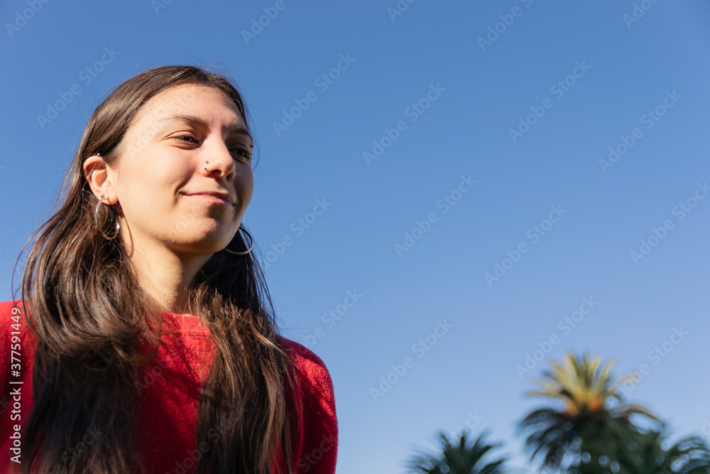 young woman with blue sky copy space happy, positive concept women campaign, female social media advertising young woman with blue sky copy space happy, positive concept women campaign, female social media advertising
