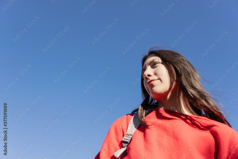 young woman with blue sky copy space happy, positive concept women campaign, female social media advertising young woman with blue sky copy space happy, positive concept women campaign, female social media advertising