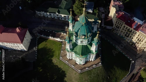 Orthodox Church on green hill in the city Kyiv, Ukraine. Aerial View of St. Andrews Church in the morning photo