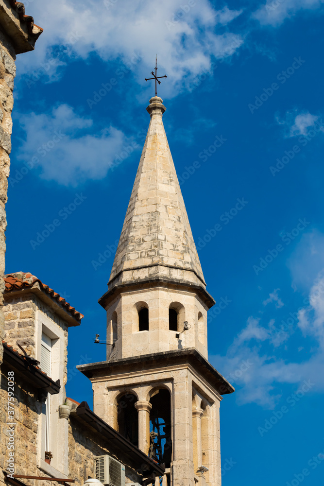 The top of the old church in the city of budva, a bright saturated photo of architecture
