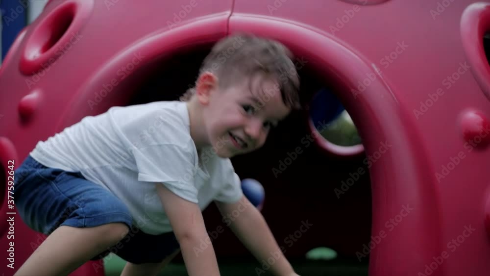 Happy smiling boy outdoors, child playing on a swing in the park. Child emotion concept. Summer sunny day Small children or happy children play outdoors. Children's activities. Happy smiling boy outdoors, child playing on a swing in the park. Child emotion concept. Summer sunny day Small children or happy children play outdoors. Children's activities.