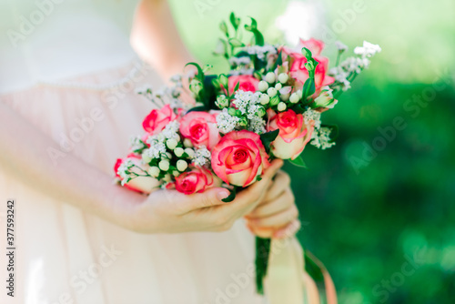 Wedding bouquet of white and red roses in bride's hands