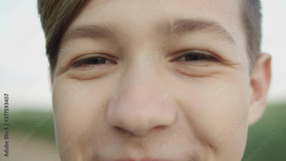 portrait of a boy looking at the camera and smiling, close-up of eyes portrait of a boy looking at the camera and smiling, close-up of eyes