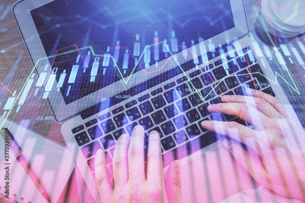 Double exposure of man's hands typing over computer keyboard and forex graph hologram drawing. Top view. Financial markets concept. Double exposure of man's hands typing over computer keyboard and forex graph hologram drawing. Top view. Financial markets concept.