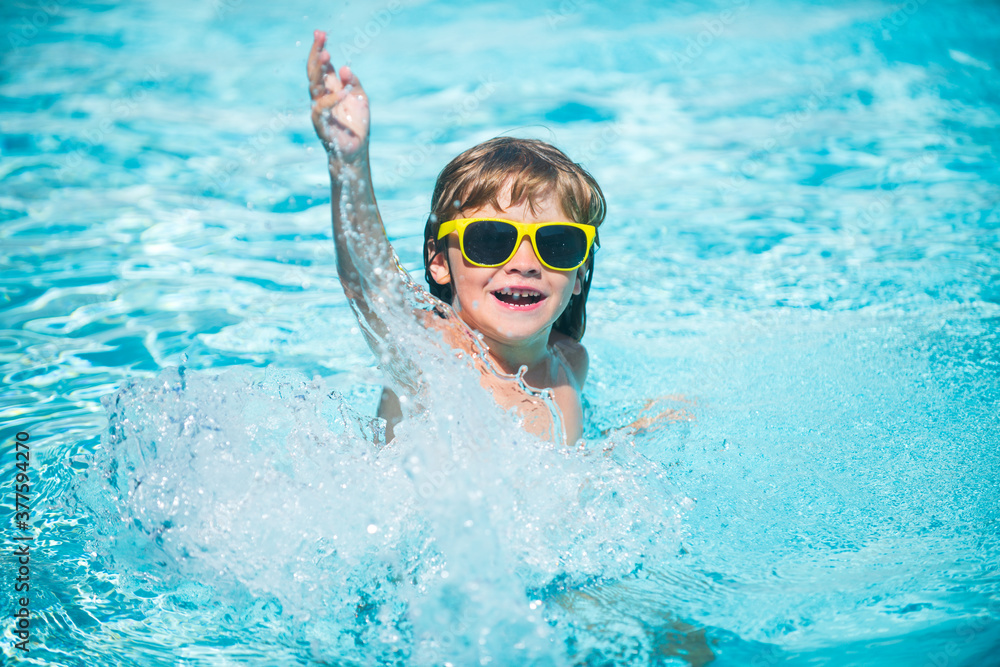 Happy kid having fun in swimming pool.