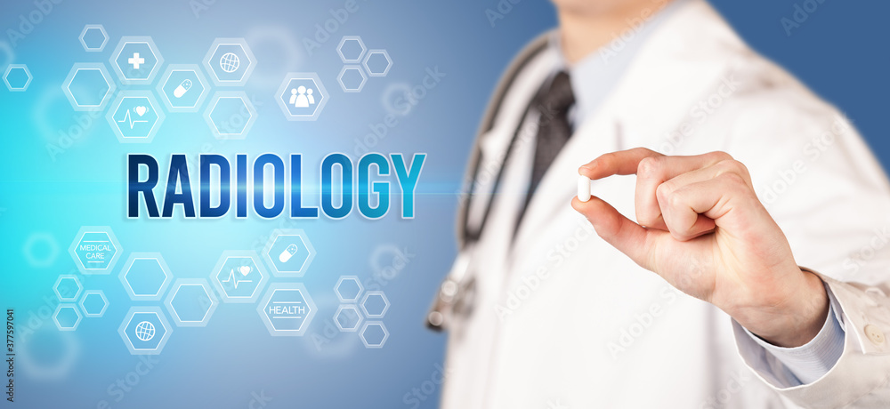 Close-up of a doctor giving you a pill with RADIOLOGY inscription, medical concept Close-up of a doctor giving you a pill with RADIOLOGY inscription, medical concept