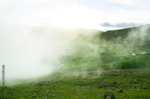 fog rises up the mountainside