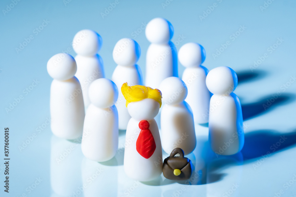 Obraz premium The concept of a team. The boss heads the team. Boss and subordinates. Leadership in the team. Symbolic little men on a light background. Political party and its leader.