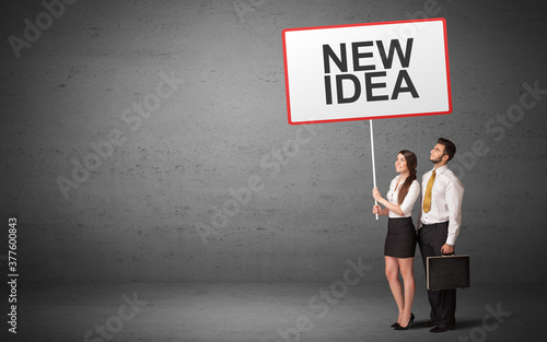 business person holding a traffic sign with NEW IDEA inscription, new idea concept