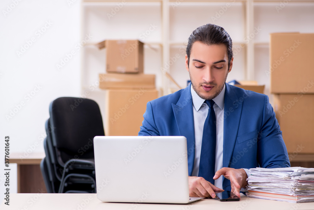 Young male employee in relocation concept Young male employee in relocation concept
