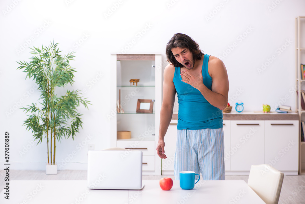 Young man waking up at home Young man waking up at home