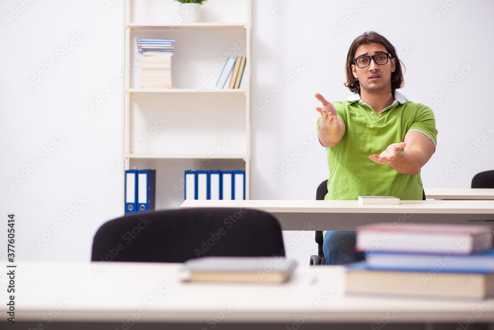 Young male student in the classroom Young male student in the classroom