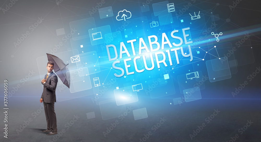 Businessman defending with umbrella from cyber attack and DATABASE SECURITY inscription, online security concept Businessman defending with umbrella from cyber attack and DATABASE SECURITY inscription, online security concept