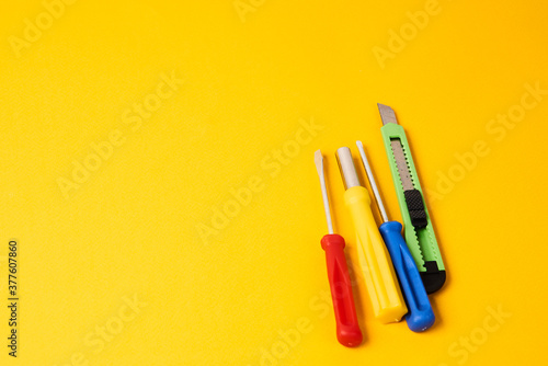 screwdrivers and construction tools on yellow background equipment for repair industry