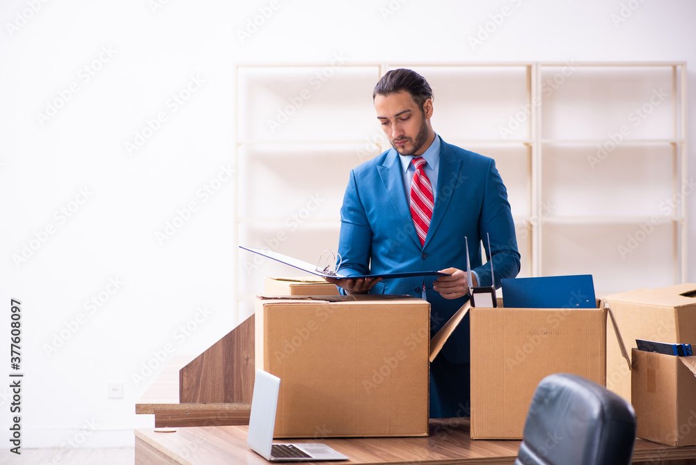Young male employee in relocation concept Young male employee in relocation concept