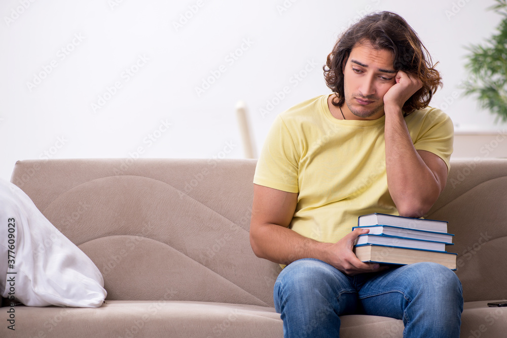 Young male student preparing for exams at home Young male student preparing for exams at home