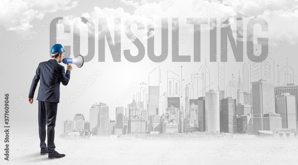 Young businessman with hard hat and CONSULTING inscription, new business opportunity concept Young businessman with hard hat and CONSULTING inscription, new business opportunity concept