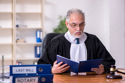 Old male judge working in courthouse