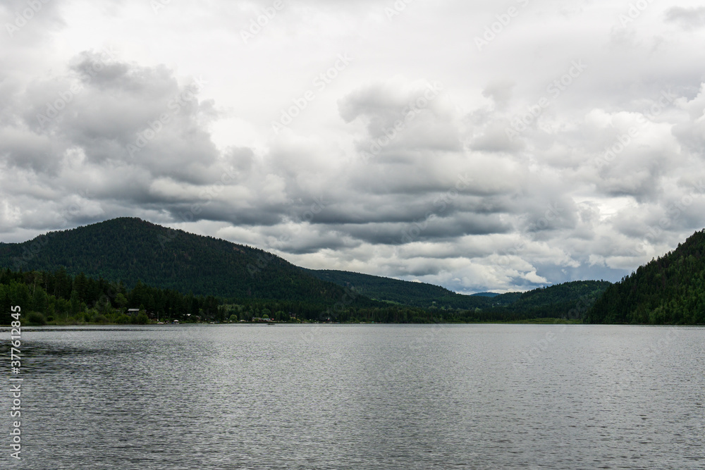 Paul Lake Summer time with green mountains and white clouds british columbia canada. Paul Lake Summer time with green mountains and white clouds british columbia canada.