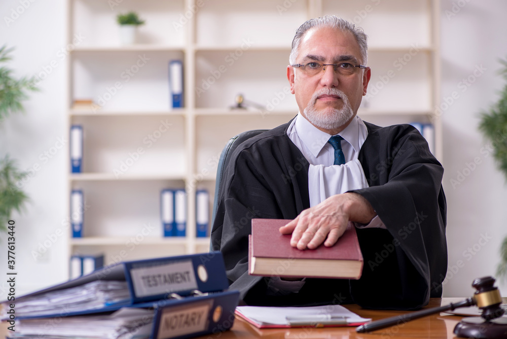 Old male judge working in courthouse Old male judge working in courthouse