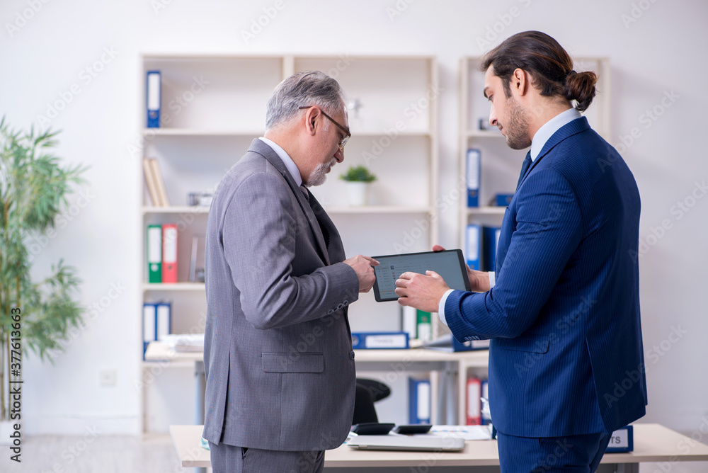 Boss and his assistant discussing company results Boss and his assistant discussing company results