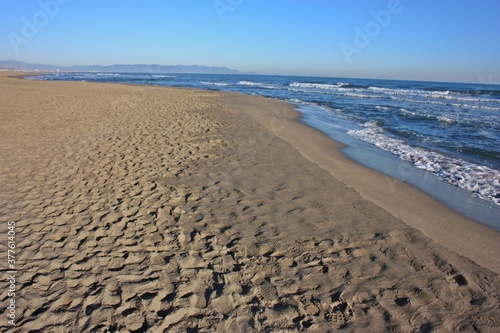 relaxing walks on the sandy beach of Versilia on a sunny day in Italian winter