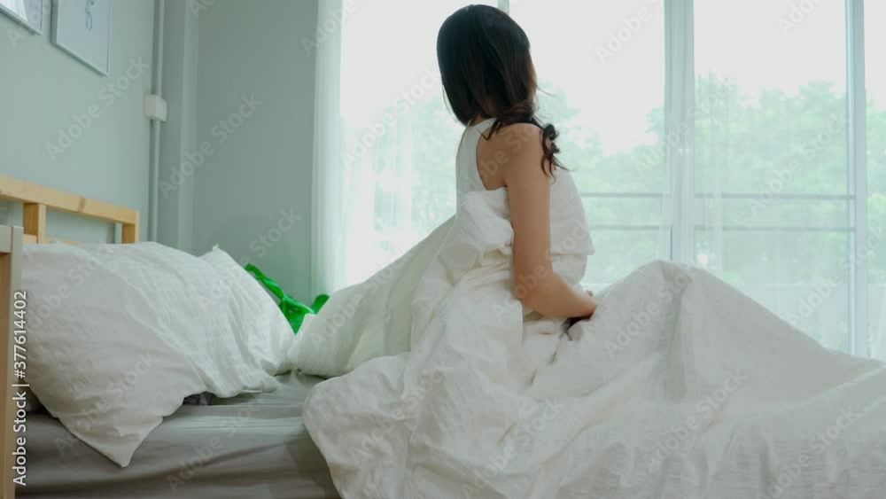 Back of view Woman stretching her arm after wake up on bed and looking outside windows in bedroom feeling so fresh and relax in the morning,Healthcare Concept Back of view Woman stretching her arm after wake up on bed and looking outside windows in bedroom feeling so fresh and relax in the morning,Healthcare Concept