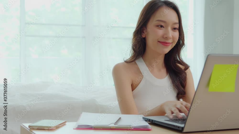 Business Startup of Young Asian women working with laptop for Online shopping at home and talking with customer to delivery order Business Startup of Young Asian women working with laptop for Online shopping at home and talking with customer to delivery order