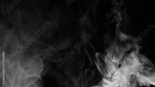 Texture of white smoke on a black background. Slow motion. Vape smoke. cigarette smoke clud. photo