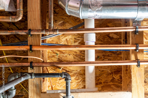 Canvas Print Residential utility room with gas, water, sewer, and electrical conduit