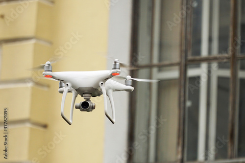    Drone on the background of the window. The concept of surveillance  espionage  information gathering  invasion of privacy.