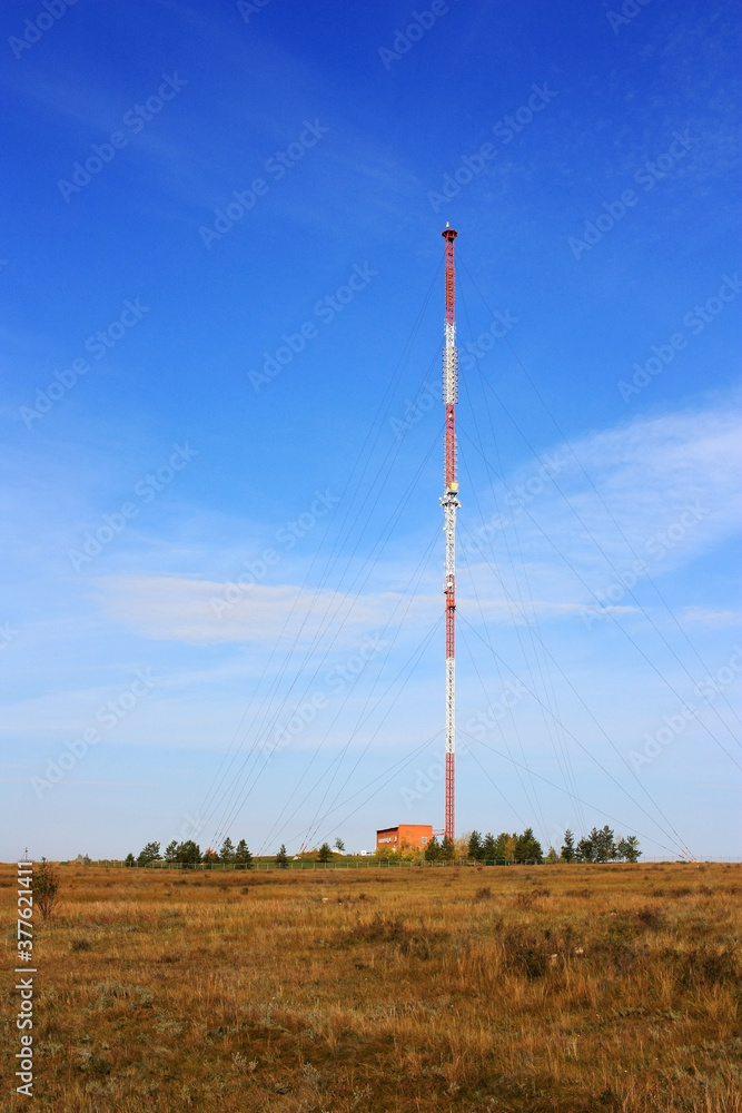 Cell tower stands in the field Cell tower stands in the field