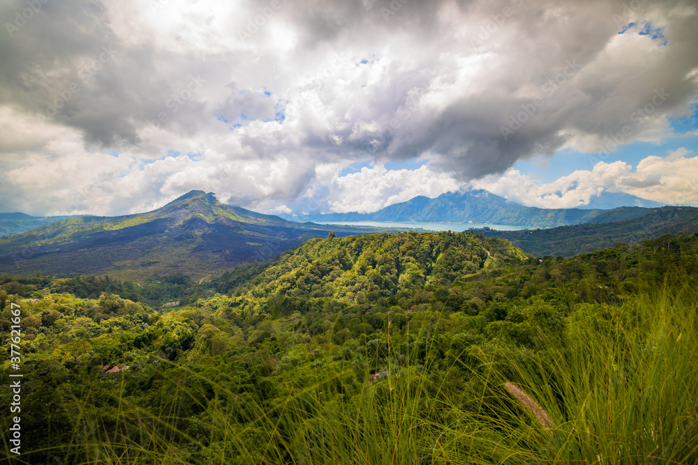 Beautiful mountain landscape. Hills and Batur volcano. Scenic panoramic view. Sky with white clouds. Kintamani, Bali, Indonesia