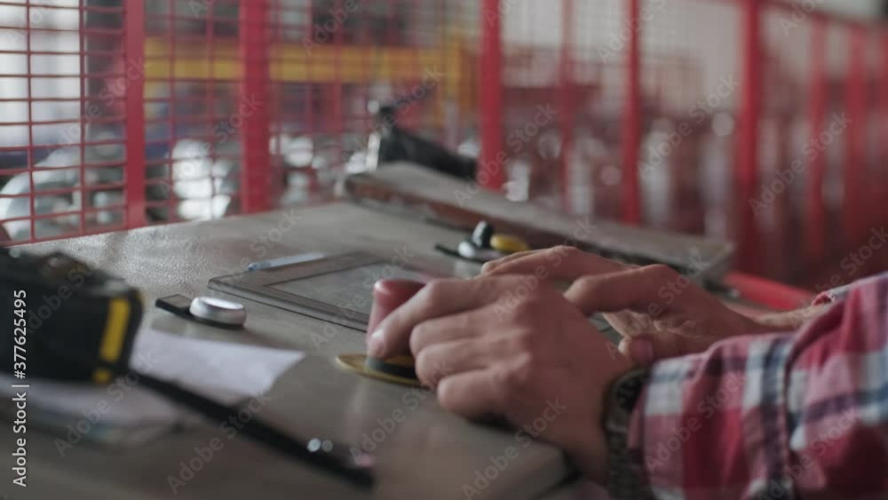 man working on the control panel works with an industrial machine at the factory close-up. man working on the control panel works with an industrial machine at the factory close-up.